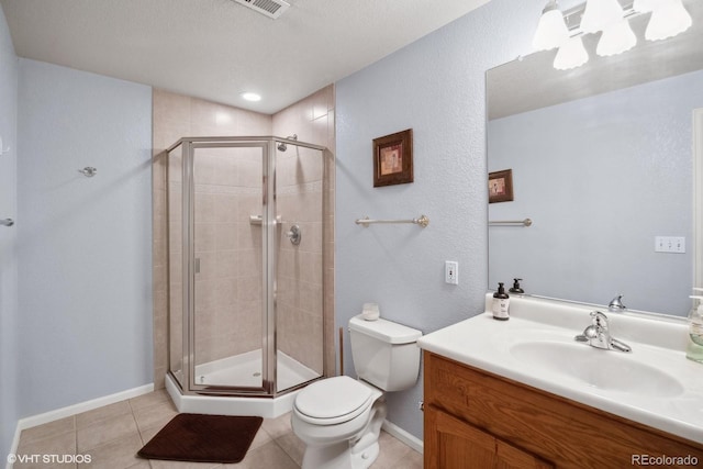 bathroom featuring a textured ceiling, toilet, vanity, an enclosed shower, and tile patterned flooring