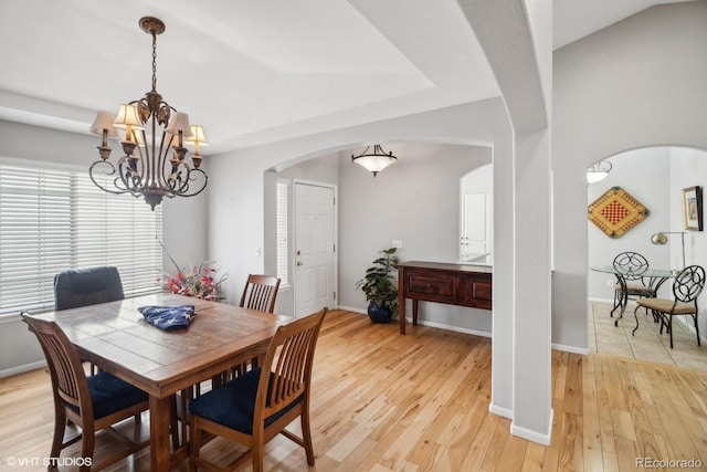 dining area featuring a notable chandelier and light hardwood / wood-style flooring