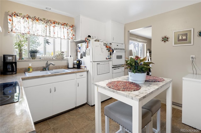 6018 S Prince St, Littleton, CO 80120 - kitchen with white appliances, a sink, white cabinets, and light countertops