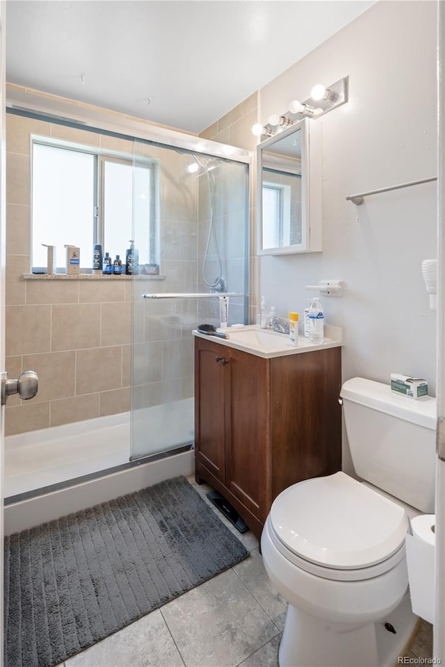 6018 S Prince St, Littleton, CO 80120 - bathroom with vanity, toilet, a shower stall, and tile patterned floors