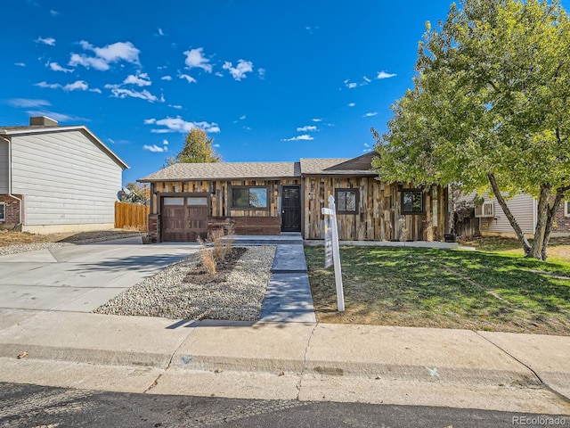 view of front of house featuring a garage and a front lawn