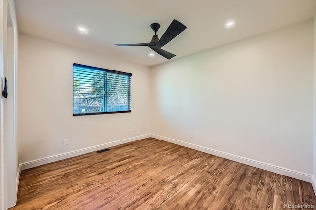 unfurnished room with ceiling fan and hardwood / wood-style flooring