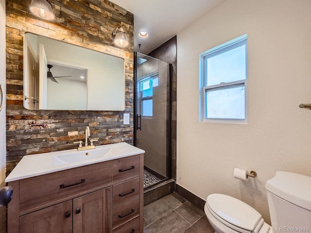 bathroom with tile patterned floors, vanity, ceiling fan, toilet, and a shower with shower door