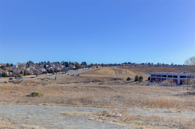 view of yard featuring a rural view and fence