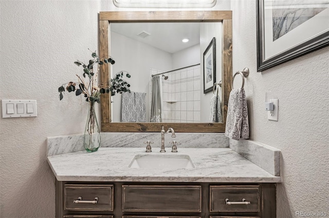 4185 Cheyenne Dr, Larkspur, CO 80118 - bathroom with vanity, a shower with curtain, and a textured wall