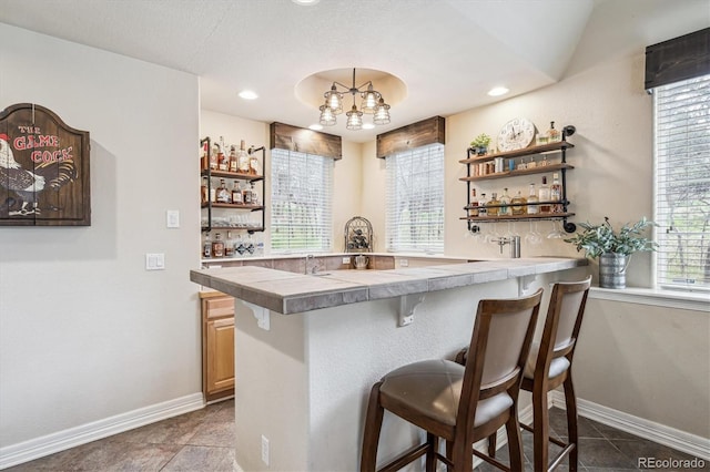 4185 Cheyenne Dr, Larkspur, CO 80118 - indoor bar featuring baseboards, a chandelier, dark tile patterned floors, and recessed lighting