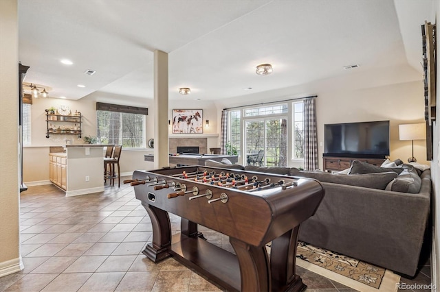 4185 Cheyenne Dr, Larkspur, CO 80118 - recreation room featuring light tile patterned floors, a tile fireplace, baseboards, and recessed lighting