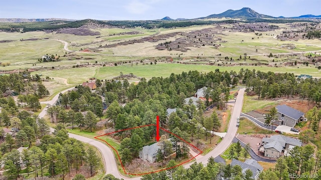 4185 Cheyenne Dr, Larkspur, CO 80118 - aerial view of property's location with property boundaries highlighted and a mountainous background