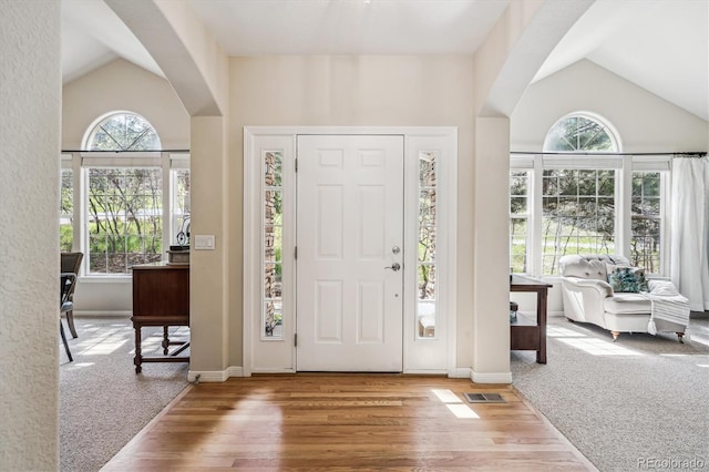 4185 Cheyenne Dr, Larkspur, CO 80118 - foyer featuring vaulted ceiling, wood finished floors, baseboards, and carpet floors
