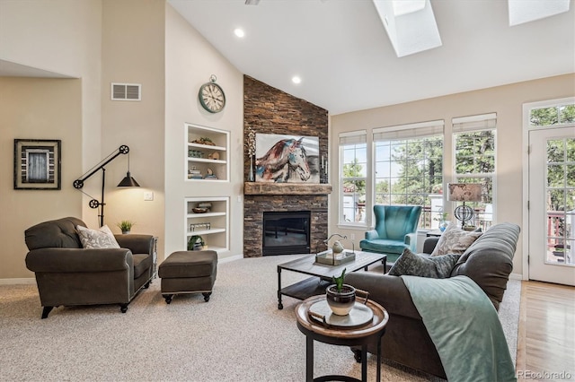 4185 Cheyenne Dr, Larkspur, CO 80118 - carpeted living area with built in features, high vaulted ceiling, baseboards, a fireplace, and a skylight