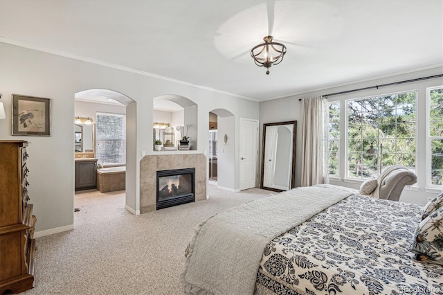 4185 Cheyenne Dr, Larkspur, CO 80118 - bedroom with light carpet, baseboards, crown molding, multiple windows, and arched walkways