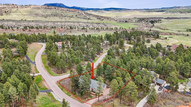 4185 Cheyenne Dr, Larkspur, CO 80118 - aerial overview of property's location with property boundaries highlighted and a mountainous background