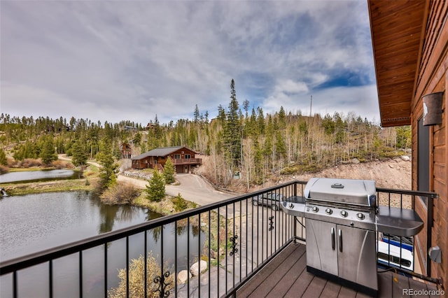 wooden deck featuring a grill and a water view