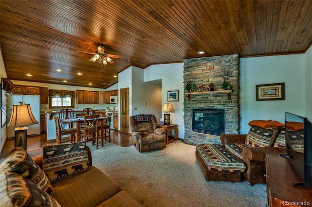 carpeted living room with a stone fireplace, ceiling fan, vaulted ceiling, and wood ceiling