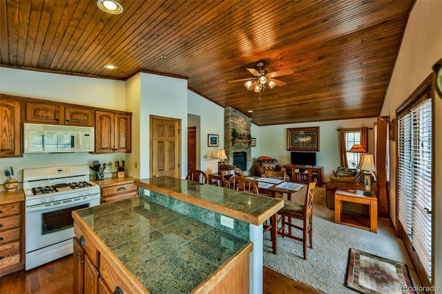 kitchen featuring wooden ceiling, ceiling fan, white appliances, and a fireplace