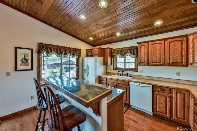 kitchen featuring refrigerator with ice dispenser, dishwasher, dark wood-type flooring, sink, and wooden ceiling