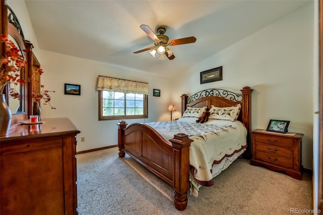 bedroom with vaulted ceiling, carpet, and ceiling fan