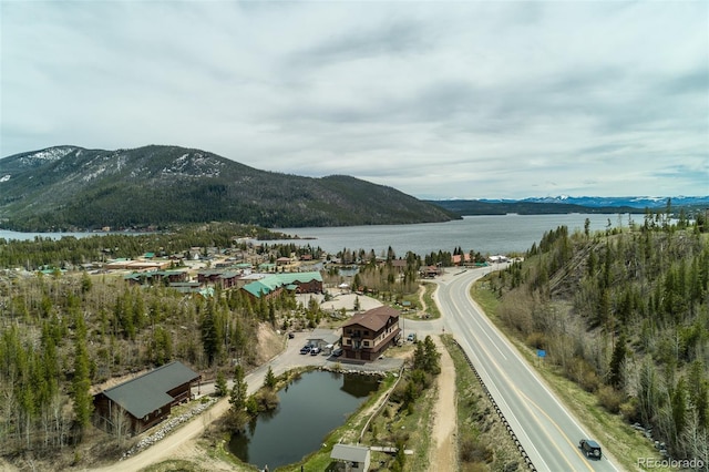 aerial view featuring a water and mountain view