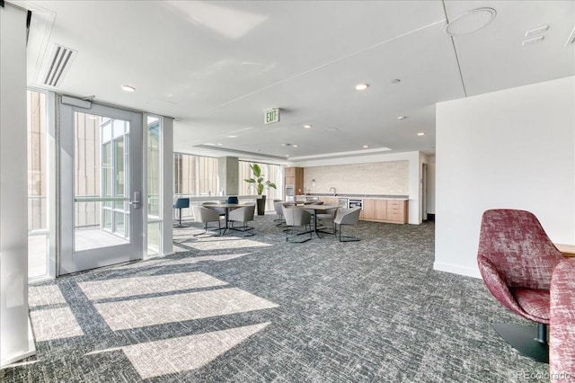 891 14th St Unit 2002, Denver, CO 80202 - living area with dark carpet, recessed lighting, and floor to ceiling windows