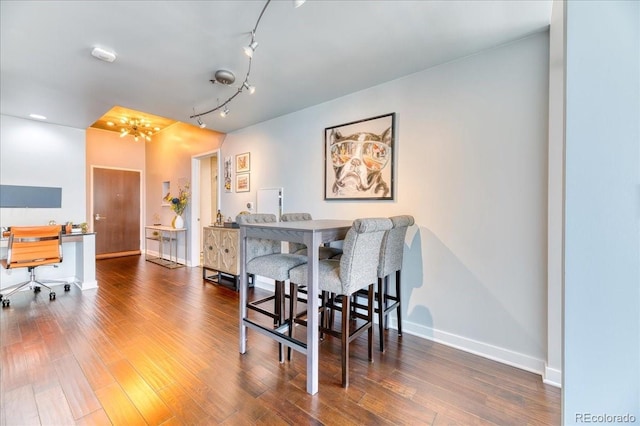 891 14th St Unit 2002, Denver, CO 80202 - dining space with a chandelier, wood finished floors, baseboards, and rail lighting