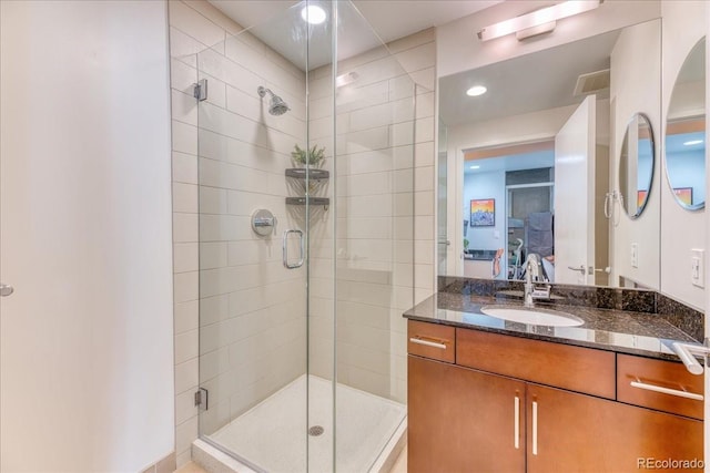 891 14th St Unit 2002, Denver, CO 80202 - ensuite bathroom featuring a shower stall, vanity, and recessed lighting