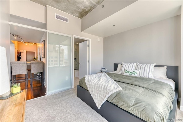 891 14th St Unit 2002, Denver, CO 80202 - carpeted bedroom featuring rail lighting and wood finished floors
