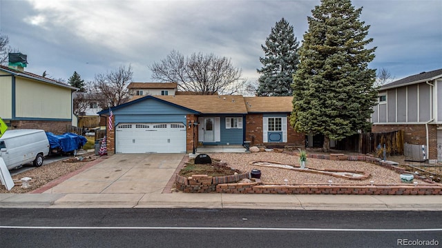 ranch-style house with fence, driveway, a garage, central air condition unit, and brick siding