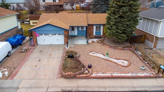 ranch-style home featuring brick siding, an attached garage, and driveway