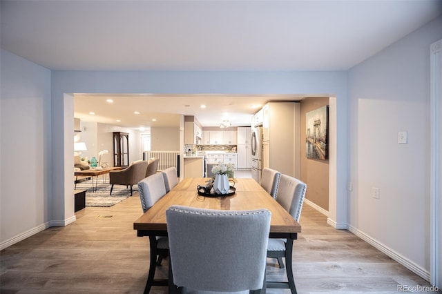 dining room featuring recessed lighting, baseboards, and light wood-style flooring