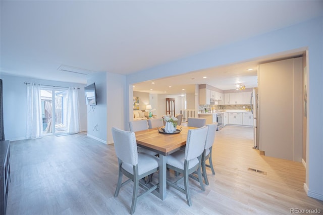 dining space with recessed lighting, visible vents, light wood-style flooring, and baseboards