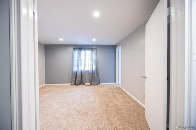 carpeted empty room featuring recessed lighting and baseboards