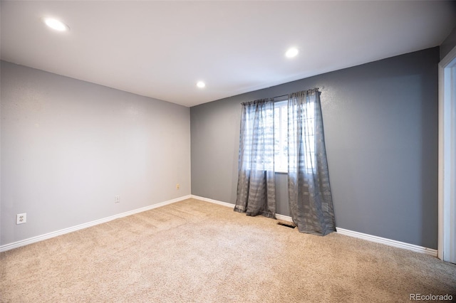 carpeted empty room featuring recessed lighting and baseboards