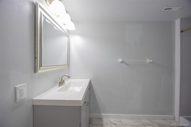 bathroom featuring visible vents, marble finish floor, vanity, and baseboards