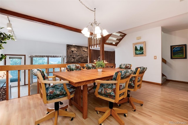 dining space with a chandelier, vaulted ceiling with beams, and light hardwood / wood-style floors