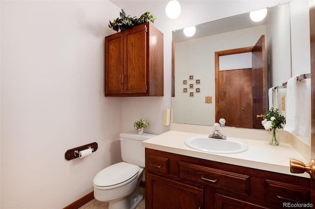 bathroom with tile patterned floors, vanity, and toilet