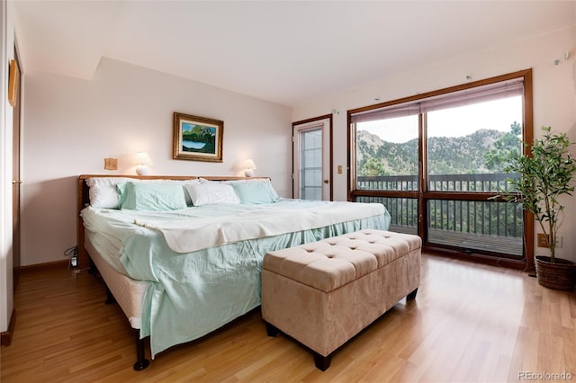 bedroom featuring hardwood / wood-style floors and a mountain view