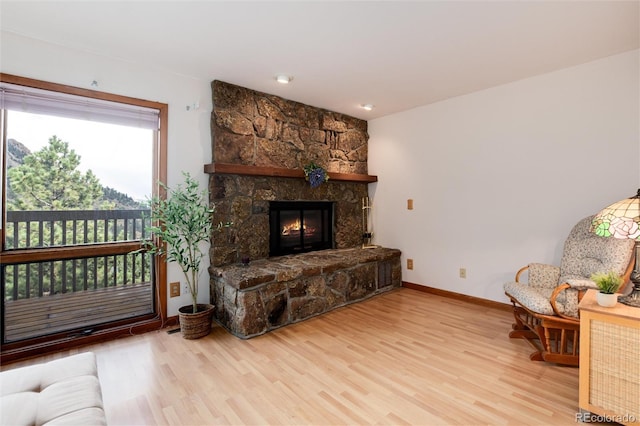 sitting room with a fireplace and light hardwood / wood-style floors