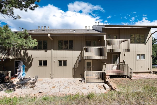 back of house featuring an outdoor fire pit and a patio area