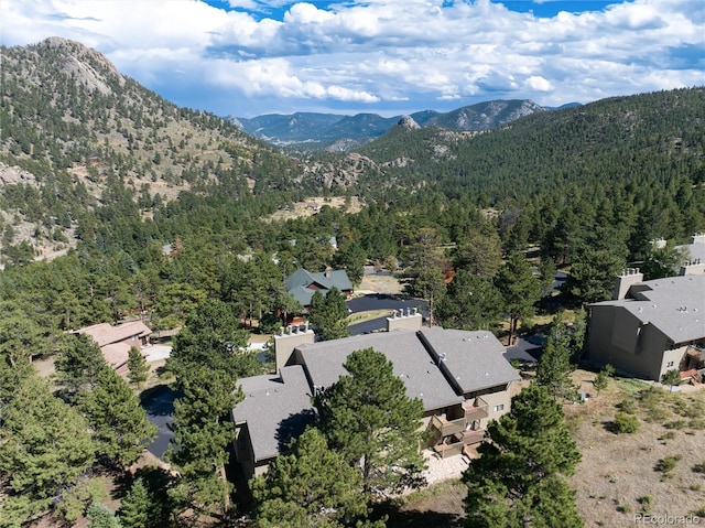 drone / aerial view with a mountain view, a residential view, and a wooded view