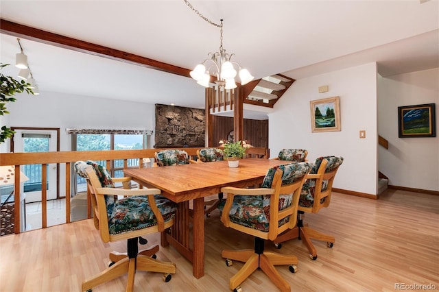 dining space with baseboards, beam ceiling, a notable chandelier, and light wood-style flooring