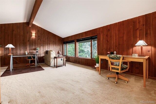 unfurnished office with carpet flooring, vaulted ceiling with beams, and wooden walls