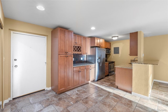 kitchen with light stone countertops, appliances with stainless steel finishes, sink, kitchen peninsula, and electric panel