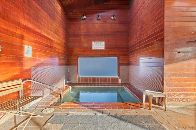 view of swimming pool with an indoor in ground hot tub