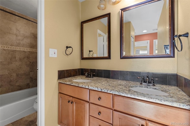 full bathroom featuring toilet, vanity, tile patterned flooring, and tiled shower / bath combo