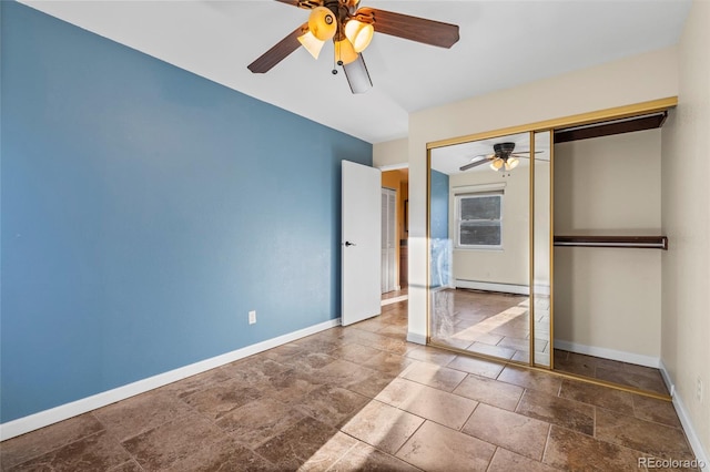 unfurnished bedroom featuring ceiling fan, baseboard heating, and a closet