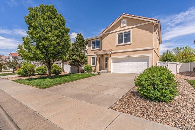 8020 Firecracker Trl, Colorado Springs, CO 80817 - traditional home with an attached garage, stucco siding, and driveway