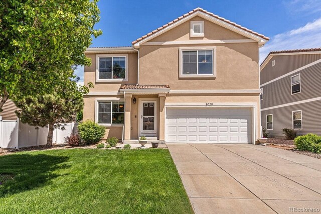 8020 Firecracker Trl, Colorado Springs, CO 80817 - traditional-style house with a garage, a tiled roof, driveway, and stucco siding