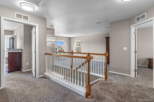 8020 Firecracker Trl, Colorado Springs, CO 80817 - hall featuring an upstairs landing, carpet floors, baseboards, and a textured ceiling