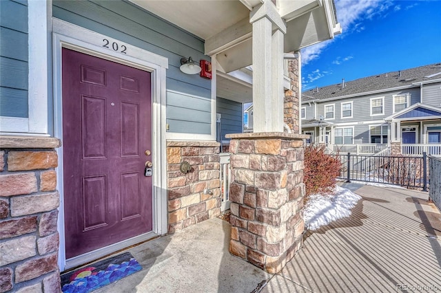 view of exterior entry featuring a porch