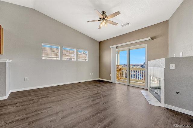 interior space with a healthy amount of sunlight, dark hardwood / wood-style flooring, ceiling fan, and lofted ceiling